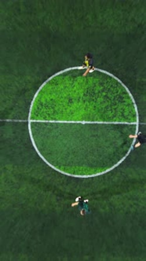 Vertical Drone Footage of mini football match, soccer. MiniFootball field and Footballers from drone