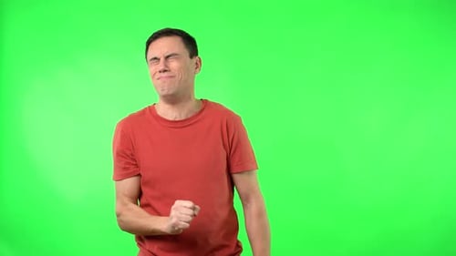 Young Adult Man Coughing on Green Background