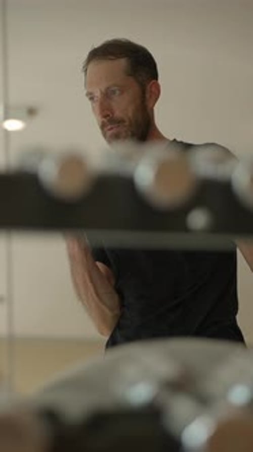 Engaging in Focused Strength Training Within a Modern and Contemporary Gym Environment