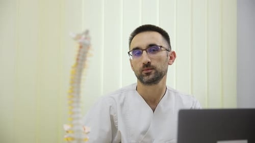 Portrait of an Orthopedic Doctor Showing an Anatomical Model of the Spine Modern Medicine