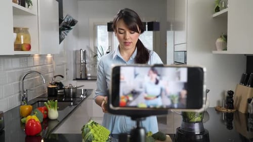 Woman Prepares Vegetables While Recording Cooking Video