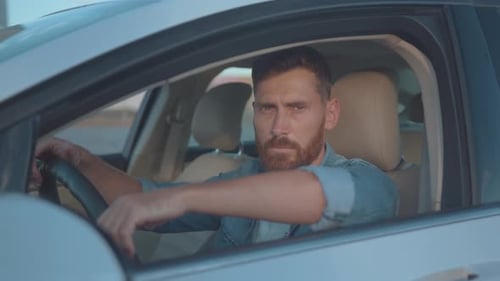 Handsome Man Sitting in Car Posing