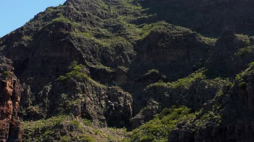 Steep volcanic rock cliff on mountain at Masca Gorge, aerial