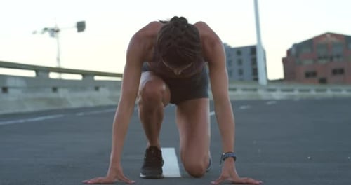Runner, athlete or sports woman running and sprinting outdoors in a city training for a sprint