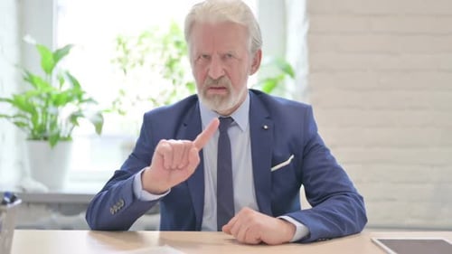 Senior Man Shakes Finger in Disagreement