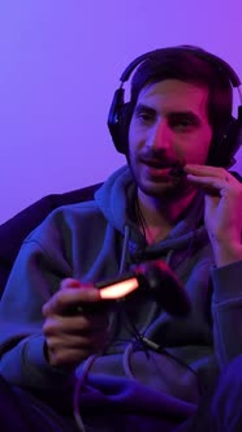 Young Adult Playing Video Games with Controller