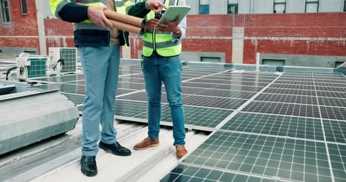 Solar panel, discussion and men on roof with tablet, development and material on building