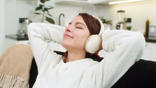 Relaxed Woman Listening to Music in Cozy Home