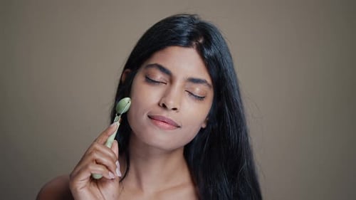 Woman Uses Jade Roller on Face
