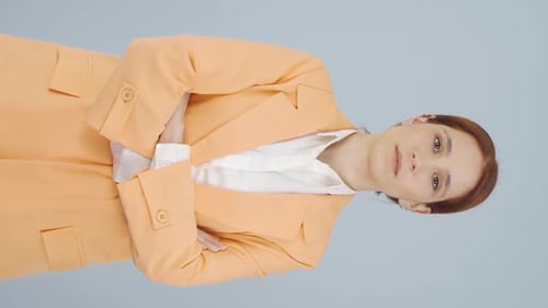Woman Poses with Arms Crossed in a Blazer