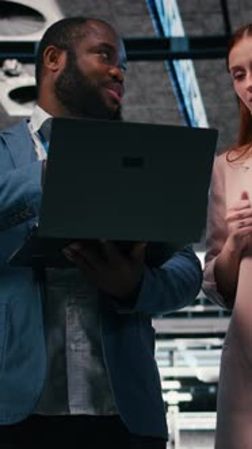 Data Center Colleagues Discuss Server Room Status on Devices