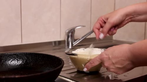 Woman Preparing Pancake Batter in a Glass Bowl