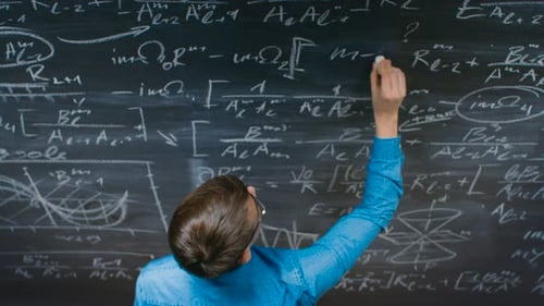 High-Angle Shot of a Brilliant Young Student Writing Complex Mathematical Formula/ Equation on the