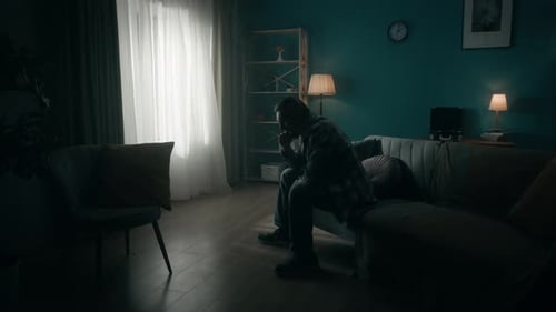 A Devastated Young Man Sits in a Room in the Dark and Alone Change of Day and Night Transience of