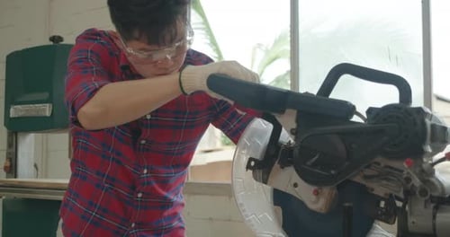 Worker young asian man carpenter building design and cutting wooden