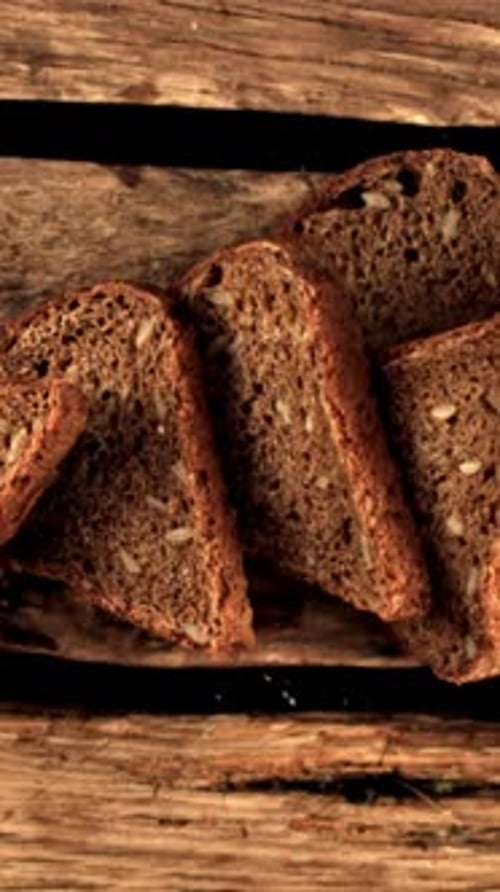 Super Slow Motion Pieces of Fresh Bread Fall on the Table Filmed on a Highspeed Camera at 1000 Fps
