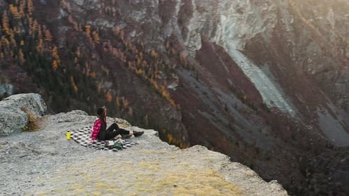 Woman Looking at Mountain Landscape Sitting on Cliff Edge Travel Inspiration Concept