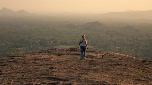 Mature Woman Exploring, Walking on Hill 30s