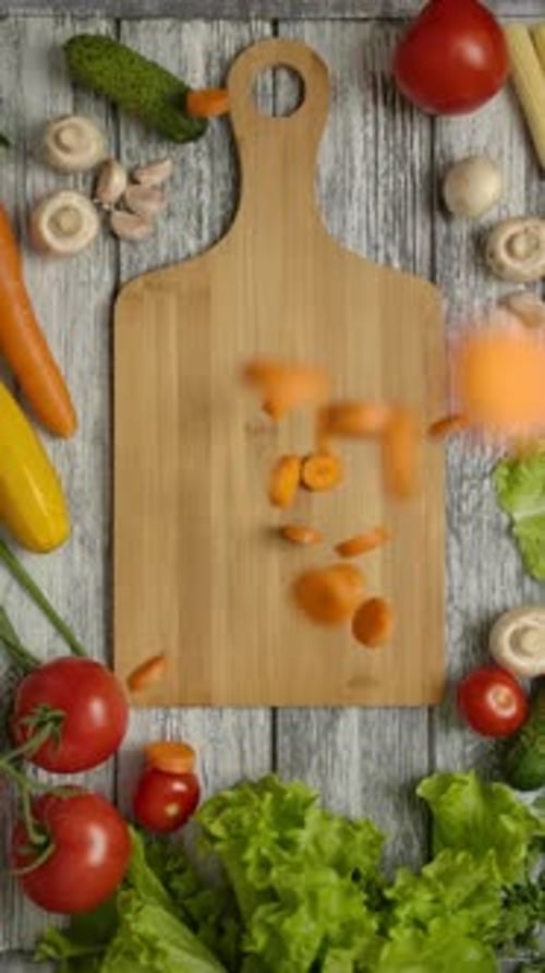 Vertical of Carrot Slices Falling on Cutting Board