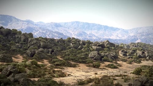 A Majestic Mountain Range Surrounded By Lush Trees and Rugged Rocks