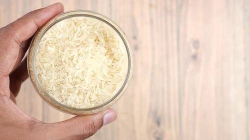Men Holding a Bowl on Rice Top View