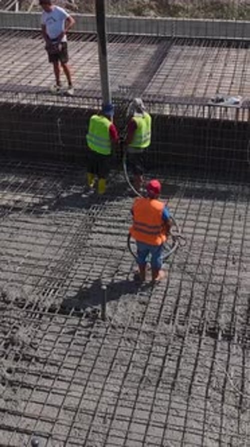 Vertical Video Construction Complex in Its Final Stage with Workers Completing Building Details and