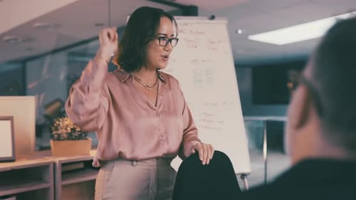 Woman Presenting in Modern Workplace Office