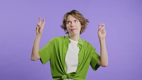 Woman Gesturing and Making Faces on Purple Background