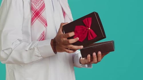Islamic Man Opening Giftbox with Bow