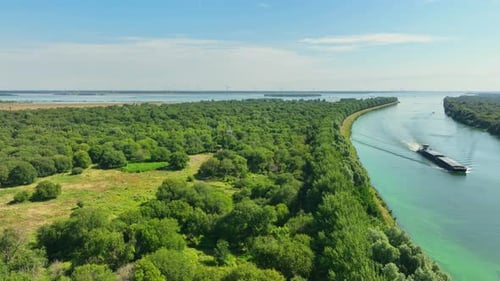 Large cargo ship on canal in Zeeland, Netherlands. Aerial view.