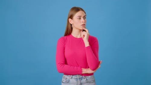 Thoughtful Woman Brainstorming Problem Solution in Studio