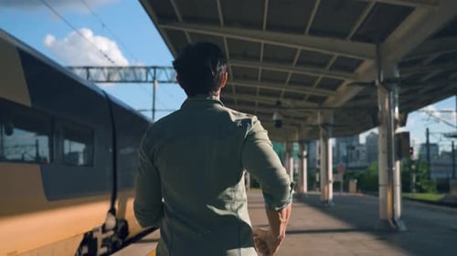 Man Traveler Running to Catch Departing Train at Railway Seoul Station. Rear View of Passenger Misse