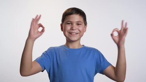 Smiling Boy Making OK Hand Gesture