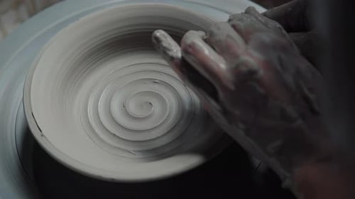Hands Shaping Clay on a Pottery Wheel