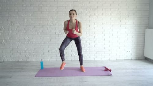 Woman Exercising on Yoga Mat in Bright Room
