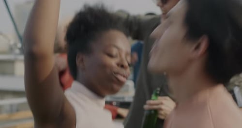 Young Adults Dancing, Laughing and Talking at Party
