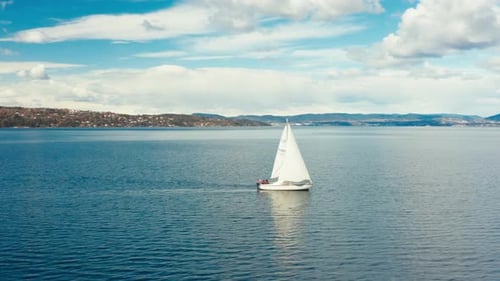 Sailboat Sailing in a Calm Ocean on a Sunny Day
