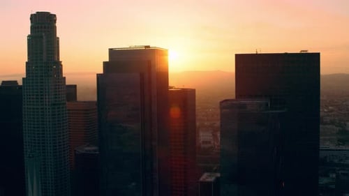 Soaring above downtown Los Angeles skyscrapers during a warm California sunset