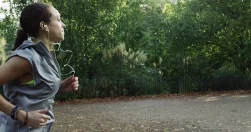 4k video footage of a woman jogging in the park