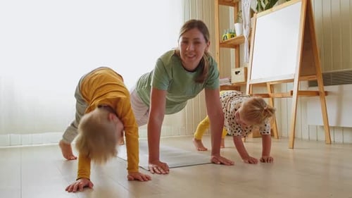 Woman and Children Doing Yoga at Home