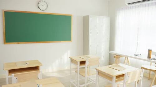 Bright Empty Classroom with Wooden Desks and Chalkboard