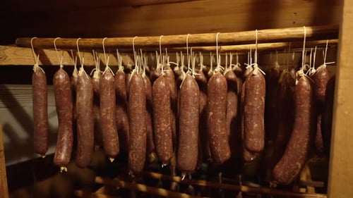 Sausages Hanging in a Dark Wooden Place
