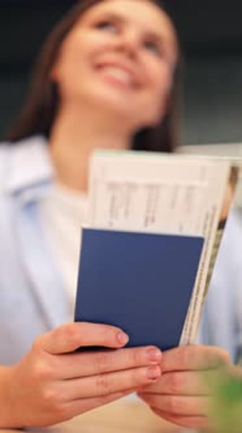 Woman Holding Passport and Plane Ticket Indoors