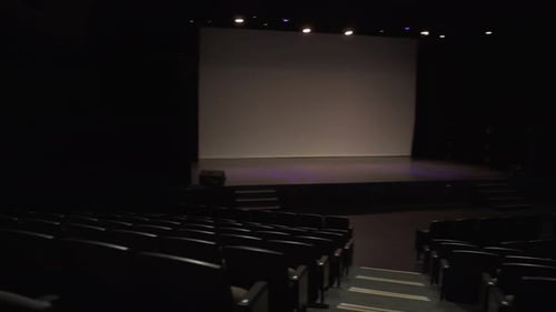 Seats And Stage In Empty Dark Auditorium
