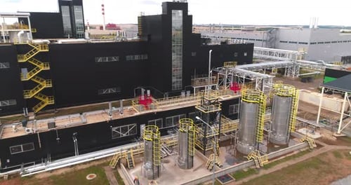 Metal Reservoirs Near Black Workshop of Chemical Plant