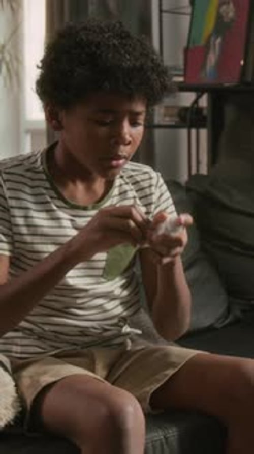 Black Boy Coughing and Using Inhaler to Relieve Asthma Attack at Home
