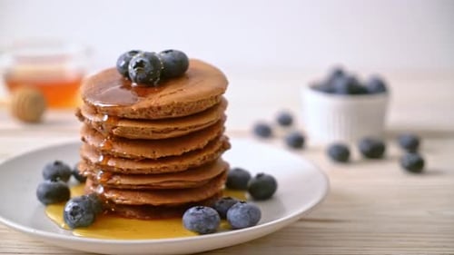Stack of Delicious Pancakes with Berries and Syrup
