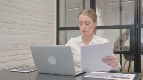 Young Woman Works at Desk on Laptop