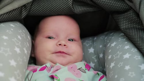 Close Up of Infant Lying in Stroller