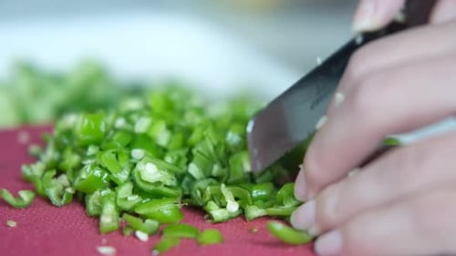 Chopping Green Peppers on Pink Cutting Board Close Up